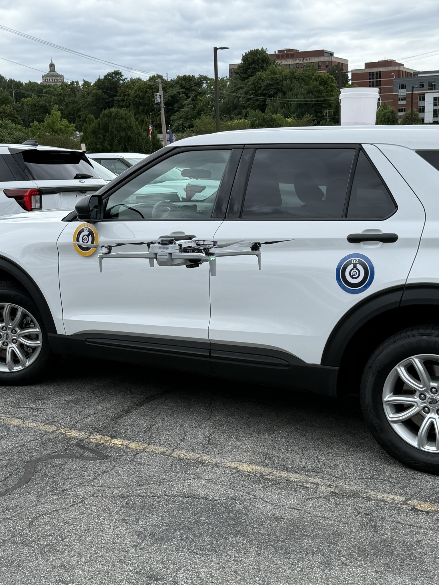 UAS hovering beside a patrol vehicle